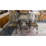 An Oak Drop Leaf Gate Leg Dining Table and Four Wheel Back Dining Chairs