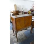 A Mid 20th Century Burr Walnut Cocktail Cabinet with Fitted Interior, Carved Pierced Apron and