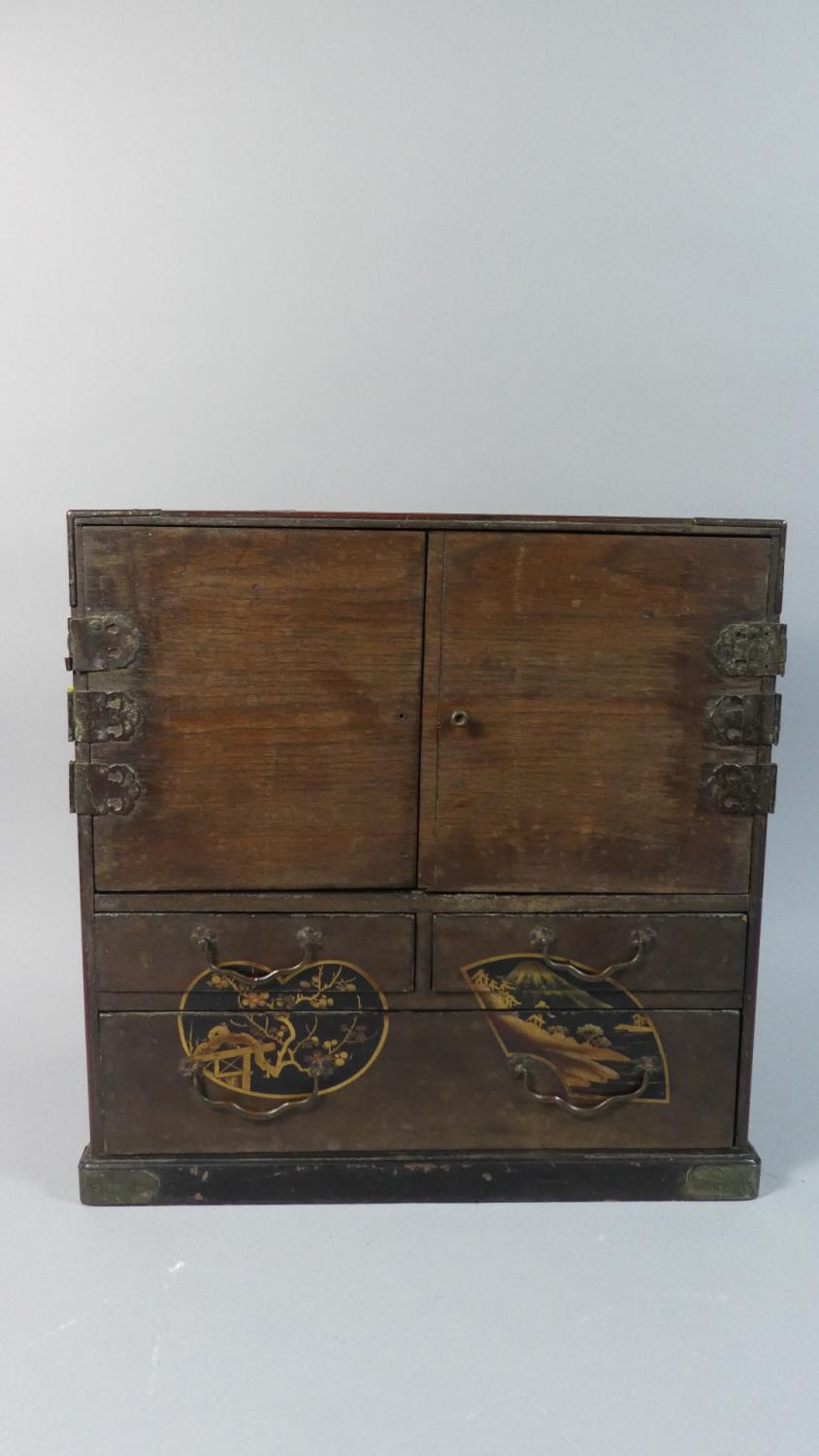 A Japanese Wooden Collectors Cabinet with Double Doors Opening to Reveal Six Lacquered Drawers,