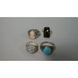 A Collection of Four White Metal Ladies Dress Rings