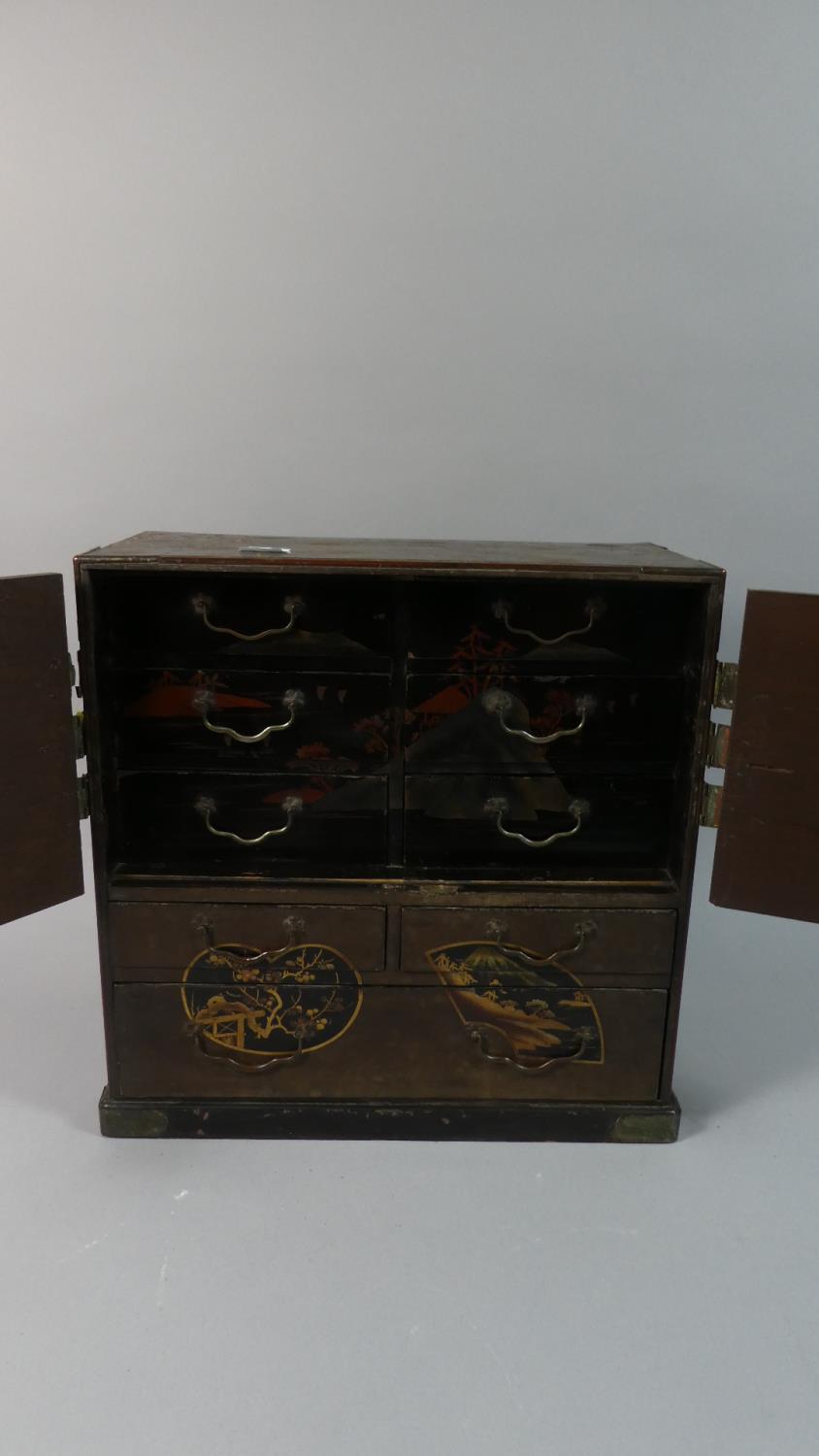 A Japanese Wooden Collectors Cabinet with Double Doors Opening to Reveal Six Lacquered Drawers, - Image 2 of 2