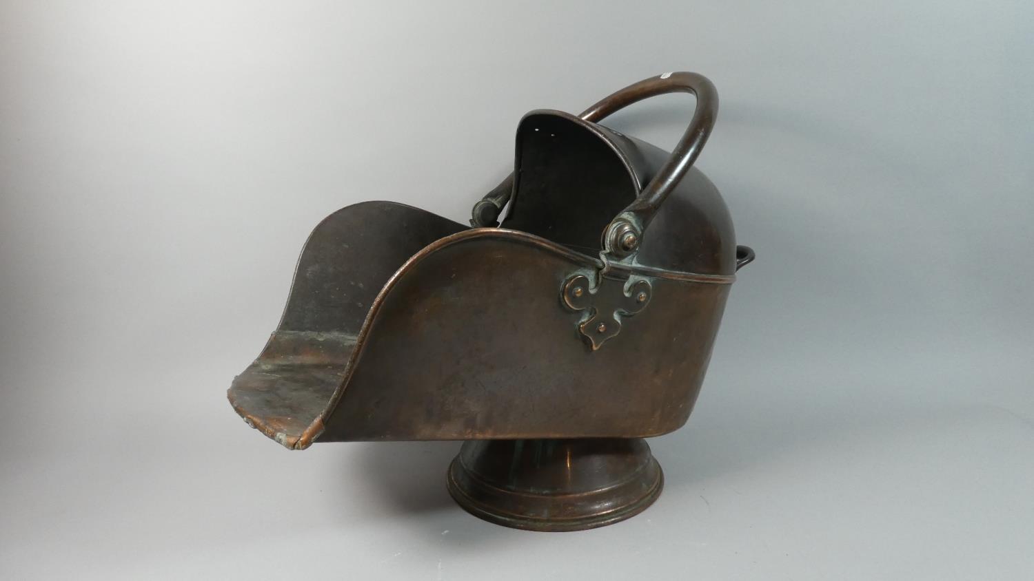 A Copper Helmet Shaped Coal Scuttle