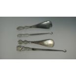 A Collection of Two Silver Handled Button Hooks and Two Silver Handled Shoe Horns