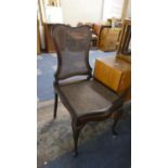 An Edwardian Mahogany Framed Cane Seated and Backed Commode Chair
