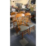 A Set of Four Spindle Backed Upholstered Seat Continental Dining Chairs