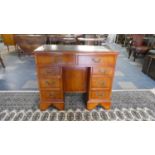 A Modern Mahogany Kneehole Desk with Tooled Leather Top, Two Top Drawers and Three Small Drawers