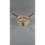 A Set of Three 1950's Red and Cream Enamelled Saucepans