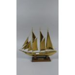 A Brass Model of 'Sir Winston Churchill' Three Masted Sailing Ship on Wooden Plinth, 27cm Long