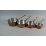 A Graduated Set of Four Copper Saucepans with Brass Handles, the Largest 16cm Diameter