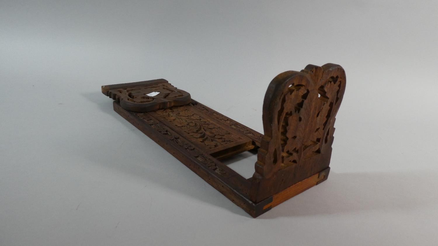 An Indian Carved Sliding Bookrest with Pierced Hinged Ends, 33cm When Closed