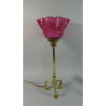 A Benson Style Table Lamp with Flared and Wavy Cranberry Glass Shade, On Three Supports having