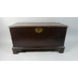 An Early 18th Century Welsh Oak Coffer Bach with a Moulded Plank Top over Dovetailed Sides,