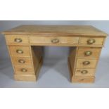 A Stripped Pine Kneehole Desk, The Crossbanded Top with One Long and Two Short Drawers Under.