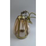 An Early 20th Century Arts and Crafts Hall Lantern with a Riveted Brass Frame and Globular Amber