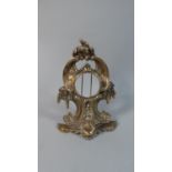 A 19th Century Polished Bronze Fob Watch Stand with Pierced Rococo Decoration. 18cms High