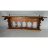 A Continental Oak Hanging Wall Shelf with a Plank Top over an Open Multi Arched Back Flanked by