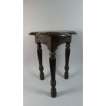 An Unusual Old Oak Joint Stool with a Moulded Triform Plank Top over Carved Pierced Side Rails.