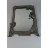 A Pewter Art Nouveau Mirror, Frame Depicting Maiden beside Tree. 25x356cms