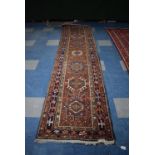 An Antique Hand Made Heriz Runner, 338x82cms