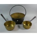 A Vintage Brass Jam Kettle with Iron Loop Handle and Two Brass Saucepans with Iron Handles