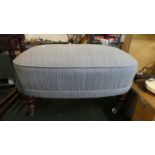 A Modern Upholstered Footstool on Turned Supports and Castors