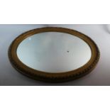 An Edwardian Gilt Framed Oval Mirror, 72cms Wide