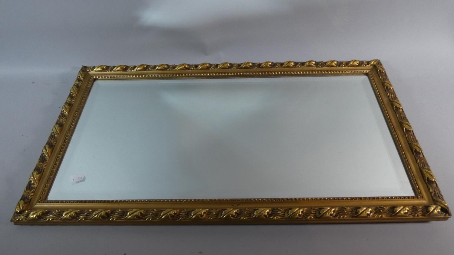 A Rectangular Wall Hanging Gilt Framed Mirror with Bevelled Glass, 68cm High