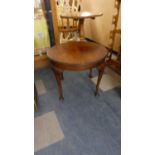 A Circular Walnut Coffee Table and an a Loom Armchair