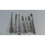 A Collection of Silver Handled Items to Include Forks, Button Hooks and a Butter Knife