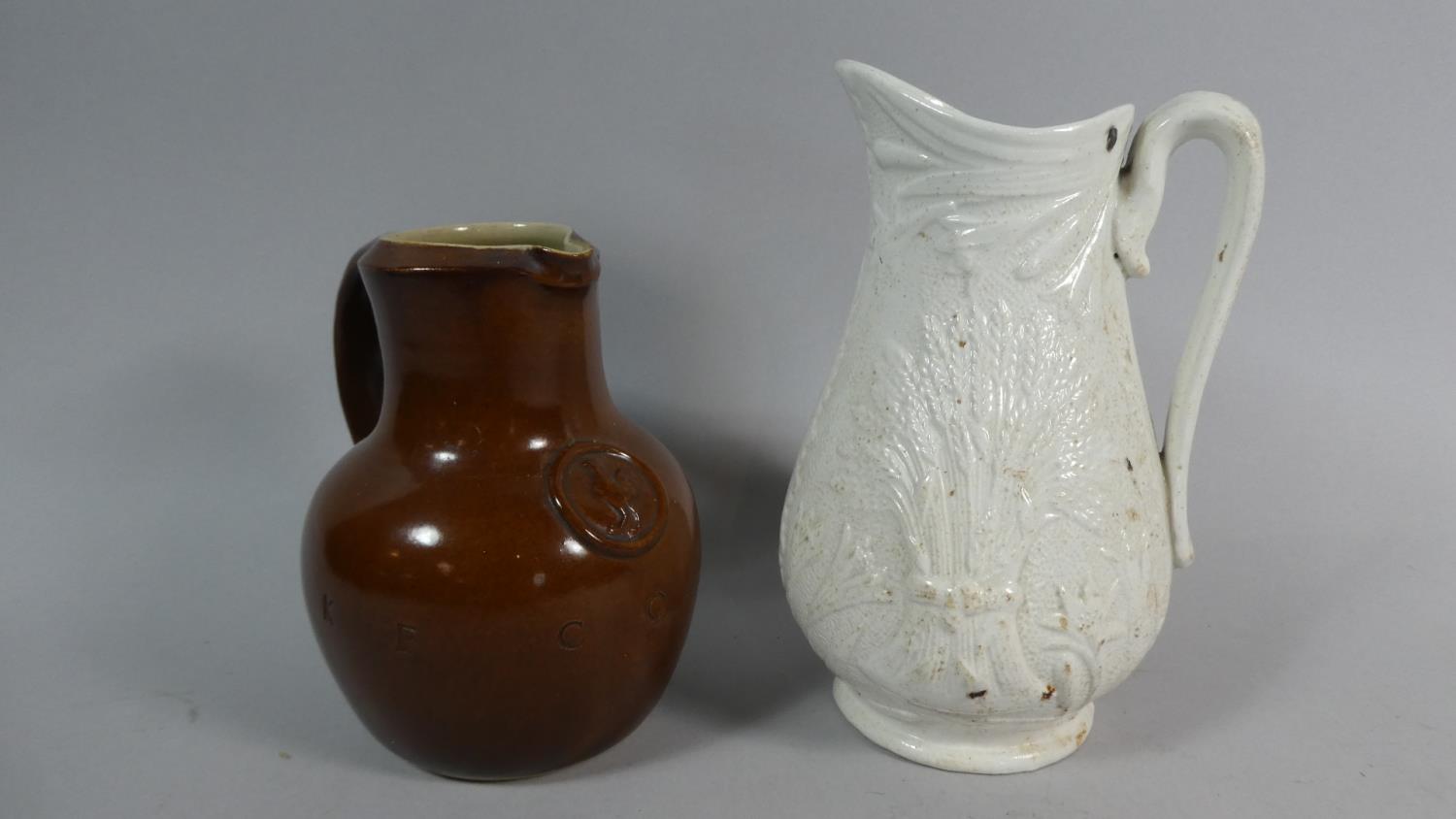 A Stoneware Glazed 'Take Courage' Pub Jug, 15cm High Together with a Moulded Pittcher with Harvest