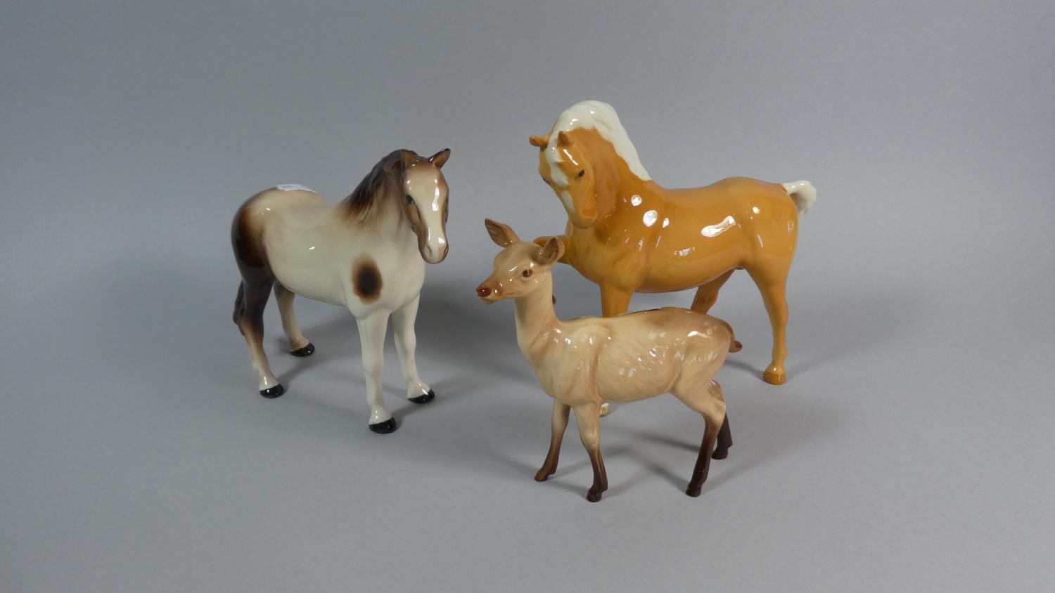 A Beswick Palomino, Beswick Hind and a Melba Horse