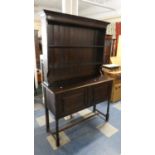 An Edwardian Oak Dresser with Panelled Doors to Cupboard Base and Two Shelf Plate Rack, 120cm Wide