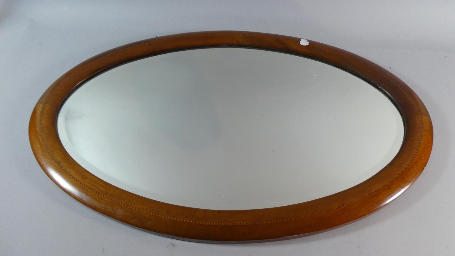 An Edwardian Oval Wall Mirror with Inlaid Mahogany Frame, 75cm Wide