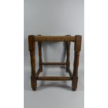 An Oak Framed Square Topped Rush Seated Stool