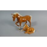 A Beswick Palomino Horse and a Reclining Foal