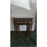 A Nest of Three Mahogany Tables with Tooled Leather Tops