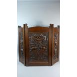 A Carved Oak Three Fold Fire Screen Decorated In Relief with Fruit, 77.5cm high