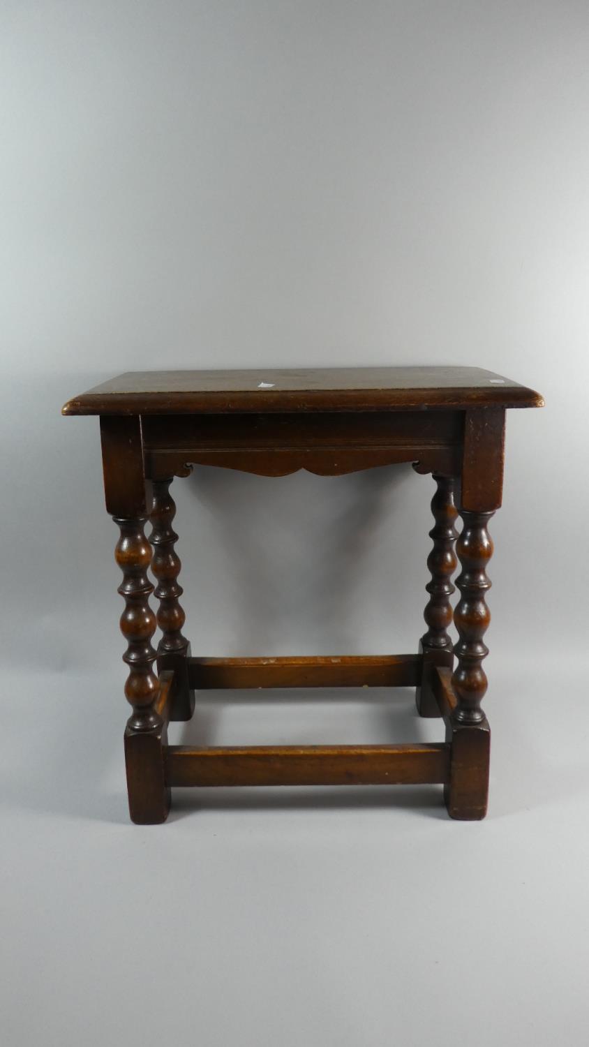 A Rectangular Oak Stool with Bobbin Supports, 47.5cm Wide