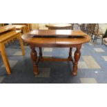 An Edwardian Oval Mahogany Dining Table with One Extra Leaf on Turned Bulbus Supports