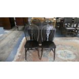 A Mid 20th Century Oak Gate Legged Drop Leaf Table and Four Wheel Back Chairs