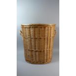An Oval Wicker Two Handled Linen Basket