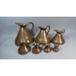 A Set of Seven Graduated Copper Measuring Jugs