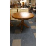 A Circular Extending Pine Dining Table, 106cm Diameter When Closed