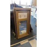 A Reproduction Gilt Framed Pier Mirror with Bevelled Glass and Marble Effect Relief Panel