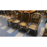 A Set of Four Elm Seated Wheel Back Dining Chairs