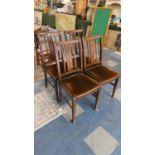 A Set of Four Edwardian Oak Framed Dining Chairs