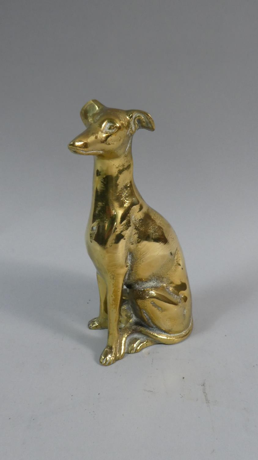 A Brass Study of a Seated Greyhound, 18cm High