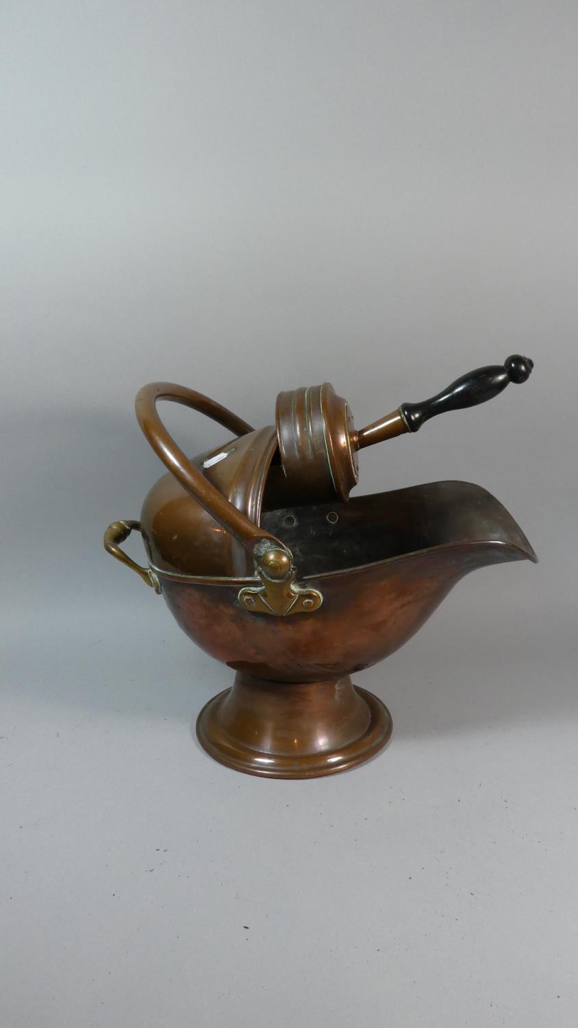 A Late 19th Century Copper Helmet Shaped Coal Scuttle with Shovel
