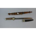 A Far Eastern Wooden Handled Dagger in Wooden and Wire Scabbard Together with a Hinged Bone