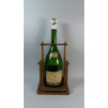 A Vintage Remy Martin Champagne Cognac Bottle in Wooden Tipping Stand, 60cm high